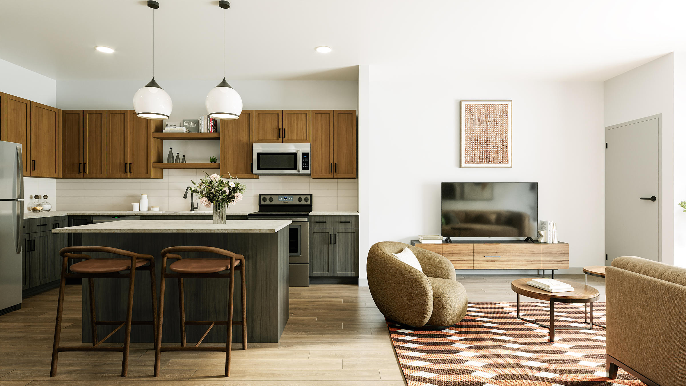 Modern kitchen and living room with wood cabinets, island seating, TV, and cozy chairs on a patterned rug.